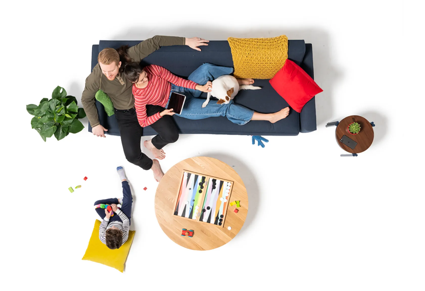 Father, mother, a child, and a dog in a living room