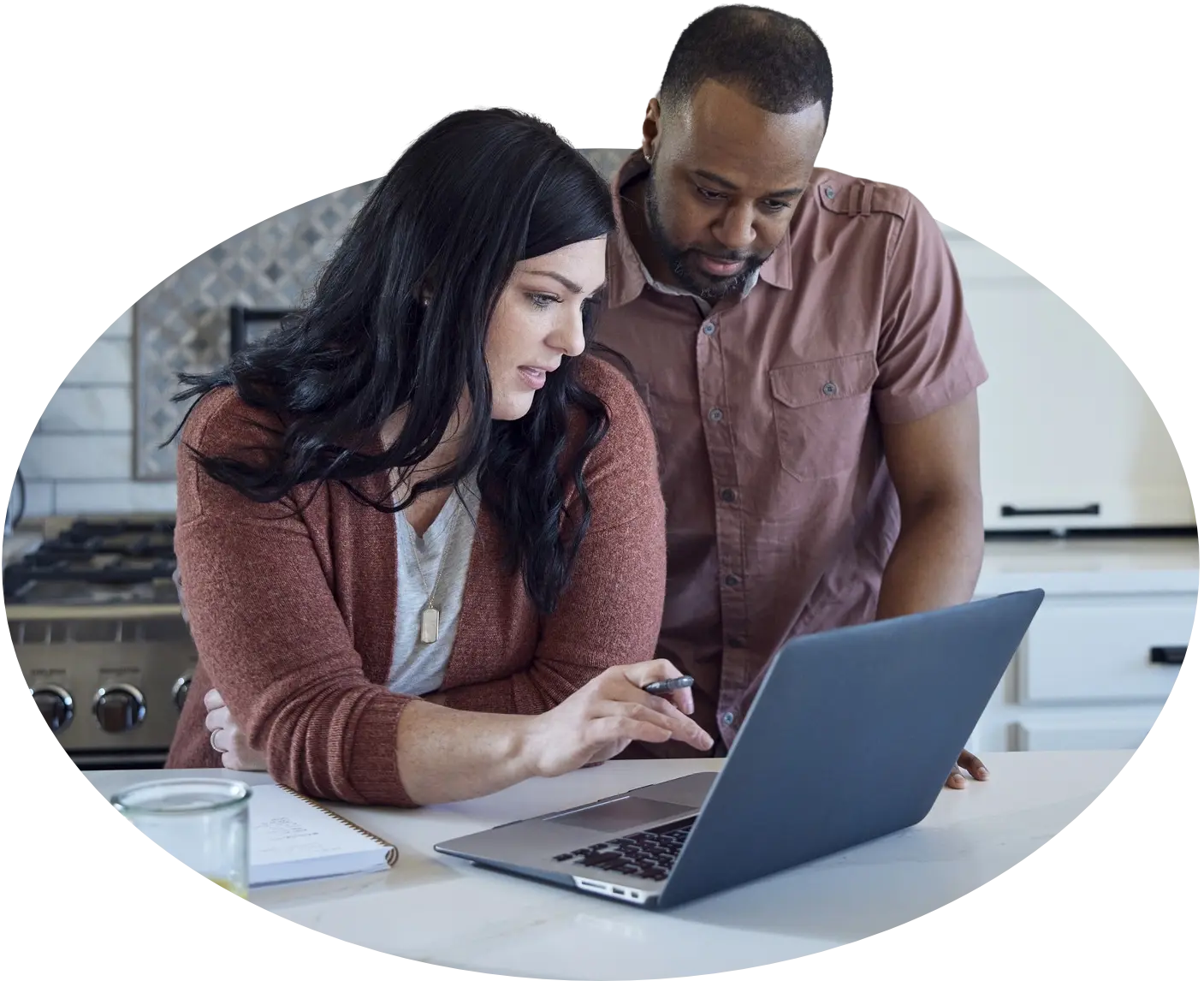 a couple researching on at a laptop in the kitchen