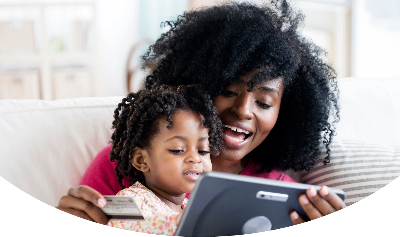 woman with daughter shopping on digital tablet