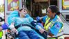 An EMT taking a boy’s blood pressure on a stretcher.