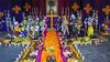A Day of the Dead altar with flowers, Catrines and other offerings.