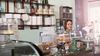 A woman small business owner stands behind the counter in her bakery.