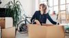 Women unpacking boxes after moving into her new place.