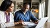 Husband and wife conduct an insurance review.