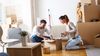 Young couple unpacking boxes at their new apartment.