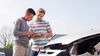 Rideshare driver exchanging insurance information with passenger after an accident.