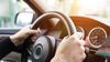 Hands on wheel of a vehicle.