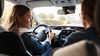 Teenager learning about driving rules from her parent.