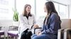 A medical professional talks with a patient.