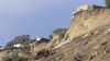 Earthquake damage to homes on a high ridge.