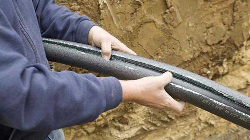 Person holding a broken pipe.