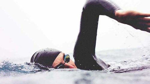Person in ocean swimming.