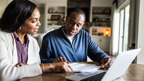 Husband and wife conduct an insurance review.