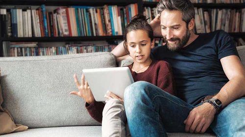 Father and teenager reviewing retirement information.